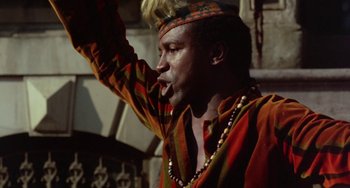 Movie still from “The Landlord” (1970), directed by Hal Ashby – A man in a colorful outfit is holding his mouth open; Close Up shot, Low angle