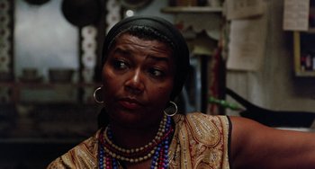 Movie still from “The Landlord” (1970), directed by Hal Ashby – A woman with a head scarf on looking into the distance; Close Up shot, Over the shoulder angle