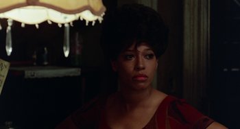 Movie still from “The Landlord” (1970), directed by Hal Ashby – A person wearing a red and black dress; Close Up shot, Over the shoulder angle