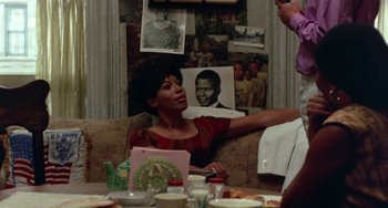 Movie still from “The Landlord” (1970), directed by Hal Ashby – A woman sitting at a table in front of a man; Medium shot, Over the shoulder angle