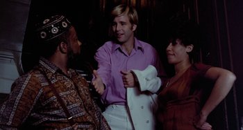 Movie still from “The Landlord” (1970), directed by Hal Ashby – Two men and a woman talking to each other; Medium shot, Over the shoulder angle