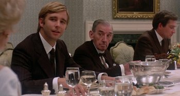 Movie still from “The Landlord” (1970), directed by Hal Ashby – Two men sitting at a dinner table with wine glasses in front of them; Medium shot, Over the shoulder angle