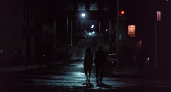 Movie still from “The Landlord” (1970), directed by Hal Ashby – Two people walking down a street at night; Wide shot, High angle