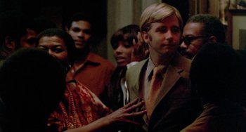 Movie still from “The Landlord” (1970), directed by Hal Ashby – A group of people standing next to each other in a room; Close Up shot, Over the shoulder angle