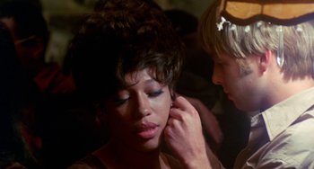 Movie still from “The Landlord” (1970), directed by Hal Ashby – A woman is putting makeup on another woman; Close Up shot, Over the shoulder angle