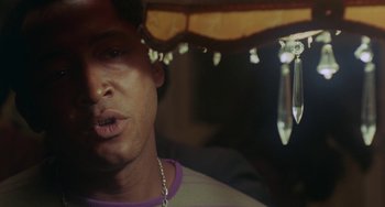 Movie still from “The Landlord” (1970), directed by Hal Ashby – A man's face under an awning; Close Up shot, Low angle