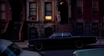 Movie still from “The Landlord” (1970), directed by Hal Ashby – A car parked on the side of the street near a building; Extreme Wide shot, High angle