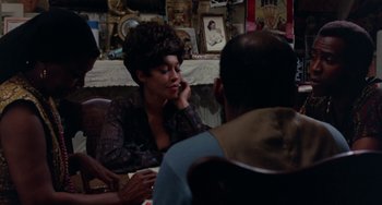 Movie still from “The Landlord” (1970), directed by Hal Ashby – A woman sitting at a table talking on the phone; Medium shot, Over the shoulder angle