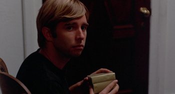 Movie still from “The Landlord” (1970), directed by Hal Ashby – A man holding a box in his hands; Close Up shot, Over the shoulder angle