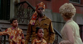 Movie still from “The Landlord” (1970), directed by Hal Ashby – A man and two women standing next to each other on steps; Medium shot, Over the shoulder angle