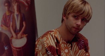 Movie still from “The Landlord” (1970), directed by Hal Ashby – A person wearing a floral shirt; Close Up shot, Over the shoulder angle