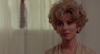 Movie still from “The Landlord” (1970), directed by Hal Ashby – A person wearing a necklace; Close Up shot, Over the shoulder angle