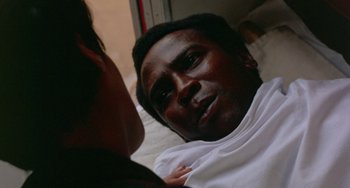 Movie still from “The Landlord” (1970), directed by Hal Ashby – A person laying on a bed; Close Up shot, High angle