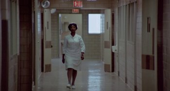 Movie still from “The Landlord” (1970), directed by Hal Ashby – A woman walking down a hallway in a hospital; Wide shot, Low angle