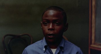 Movie still from “The Landlord” (1970), directed by Hal Ashby – A young man in a blue button up shirt; Close Up shot, High angle