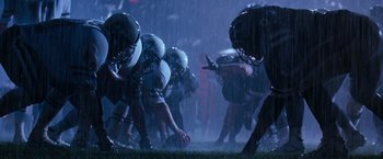Movie still from “The Last Boy Scout” (1991), directed by Tony Scott – A group of football players in a rain storm; Wide shot, High angle