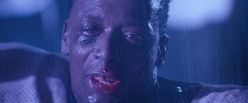 Movie still from “The Last Boy Scout” (1991), directed by Tony Scott – A person with blood on his face; Close Up shot, Low angle
