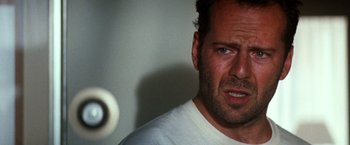Movie still from “The Last Boy Scout” (1991), directed by Tony Scott – A person wearing a white t - shirt; Close Up shot, Over the shoulder angle