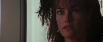 Movie still from “The Last Boy Scout” (1991), directed by Tony Scott – A woman's face in a room; Close Up shot, Over the shoulder angle