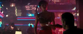 Movie still from “The Last Boy Scout” (1991), directed by Tony Scott – A woman in a black bra and red skirt; Medium shot, Over the shoulder angle