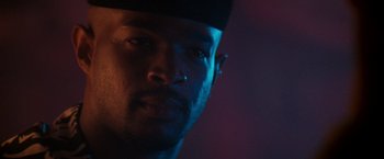 Movie still from “The Last Boy Scout” (1991), directed by Tony Scott – A person wearing a black hat; Close Up shot, Over the shoulder angle