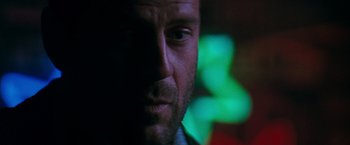 Movie still from “The Last Boy Scout” (1991), directed by Tony Scott – A man's face in front of a blurry background; Close Up shot, Low angle