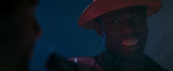 Movie still from “The Last Boy Scout” (1991), directed by Tony Scott – A person wearing a red hat; Close Up shot, Low angle