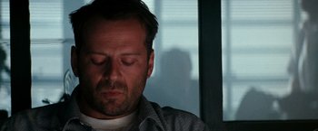 Movie still from “The Last Boy Scout” (1991), directed by Tony Scott – A person with his eyes closed; Close Up shot, Low angle