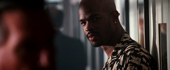 Movie still from “The Last Boy Scout” (1991), directed by Tony Scott – A person wearing a shirt; Close Up shot, Over the shoulder angle