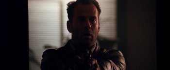 Movie still from “The Last Boy Scout” (1991), directed by Tony Scott – A person holding a gun; Close Up shot, Over the shoulder angle