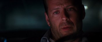 Movie still from “The Last Boy Scout” (1991), directed by Tony Scott – A man's face in the dark; Close Up shot, Low angle