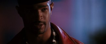 Movie still from “The Last Boy Scout” (1991), directed by Tony Scott – A person wearing a hat and a red jacket; Close Up shot, Over the shoulder angle