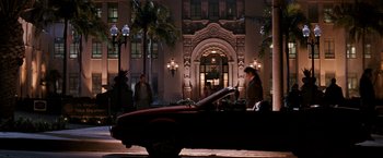 Movie still from “The Last Boy Scout” (1991), directed by Tony Scott – A car parked in front of a building at night; Extreme Wide shot, Low angle