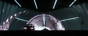 Movie still from “The Last Boy Scout” (1991), directed by Tony Scott – A car is driving through a tunnel in the dark; Extreme Wide shot, Low angle