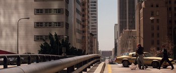 Movie still from “The Last Boy Scout” (1991), directed by Tony Scott – A street scene with cars on the side of the road; Extreme Wide shot, High angle