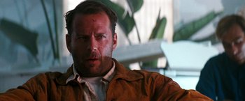 Movie still from “The Last Boy Scout” (1991), directed by Tony Scott – A person wearing a brown jacket; Close Up shot, Low angle