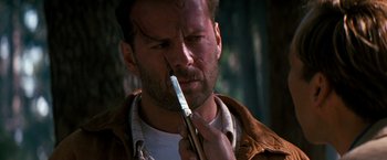 Movie still from “The Last Boy Scout” (1991), directed by Tony Scott – A person holding a pair of scissors; Close Up shot, Over the shoulder angle