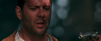 Movie still from “The Last Boy Scout” (1991), directed by Tony Scott – A man's face in a forest setting; Close Up shot, Low angle