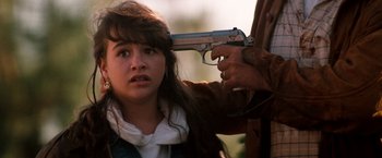 Movie still from “The Last Boy Scout” (1991), directed by Tony Scott – A woman holding a gun up to a man's face; Close Up shot, Over the shoulder angle