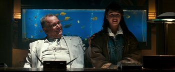 Movie still from “The Last Boy Scout” (1991), directed by Tony Scott – A man and a woman sitting next to each other at a table; Medium shot, Over the shoulder angle