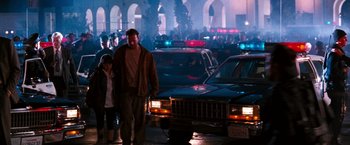 Movie still from “The Last Boy Scout” (1991), directed by Tony Scott – A man and a child walking down a street; Wide shot, Low angle