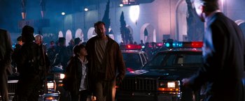 Movie still from “The Last Boy Scout” (1991), directed by Tony Scott – A man and a child walking down a street; Wide shot, Low angle