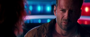 Movie still from “The Last Boy Scout” (1991), directed by Tony Scott – A man's face in front of lights; Close Up shot, Over the shoulder angle