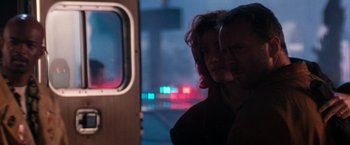 Movie still from “The Last Boy Scout” (1991), directed by Tony Scott – A man and a woman standing next to each other in front of a window; Close Up shot, Over the shoulder angle