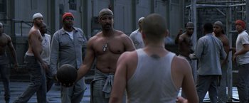 Movie still from “The Last Castle” (2001), directed by Rod Lurie – A group of men standing next to each other on a street; Medium shot, Over the shoulder angle