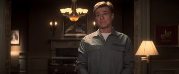 Movie still from “The Last Castle” (2001), directed by Rod Lurie – A man standing in front of a fireplace in a room; Medium shot, Over the shoulder angle