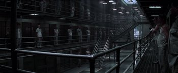 Movie still from “The Last Castle” (2001), directed by Rod Lurie – A group of people standing in a jail cell; Extreme Wide shot, High angle