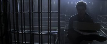 Movie still from “The Last Castle” (2001), directed by Rod Lurie – A man standing in a jail cell with a cell phone; Wide shot, High angle