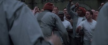 Movie still from “The Last Castle” (2001), directed by Rod Lurie – A group of men standing around each other; Medium shot, Over the shoulder angle