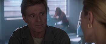 Movie still from “The Last Castle” (2001), directed by Rod Lurie – A person sitting in front of a window; Close Up shot, Over the shoulder angle